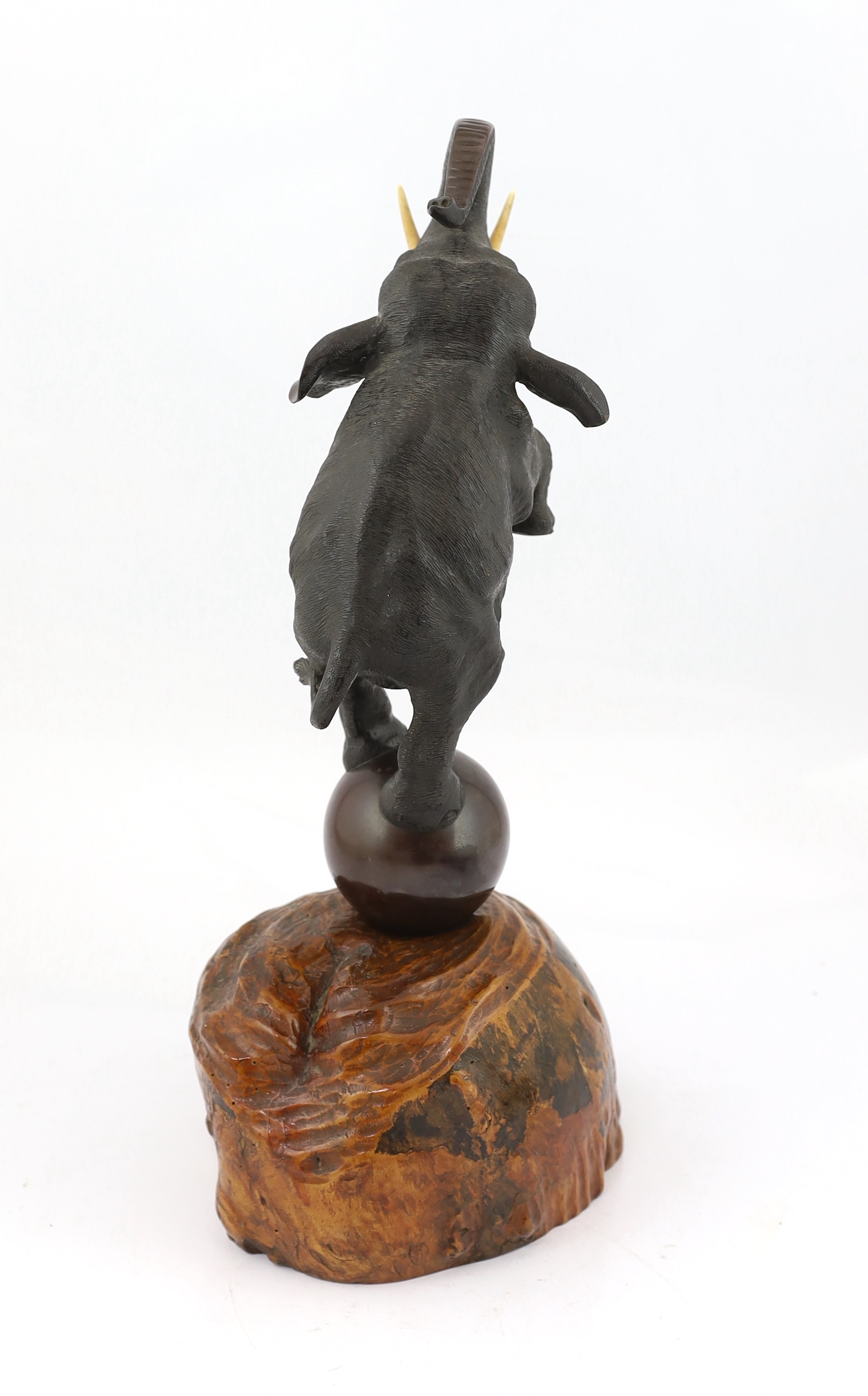 A Japanese bronze model of a rearing elephant standing on a ball, Meiji period